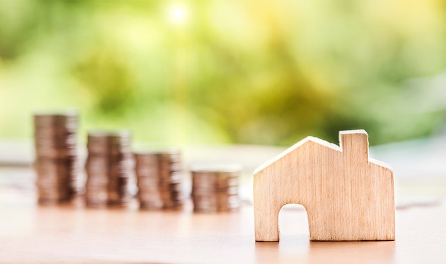 decling row of coins and figure of a house