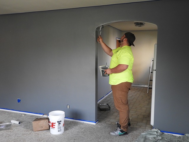 person paiting a wall